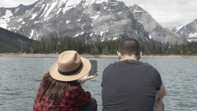 Couple taking selfie with camera phone at sunny mountain lake - Powered by Shutterstock - Get 15% off with code: PIKWIZARD15
