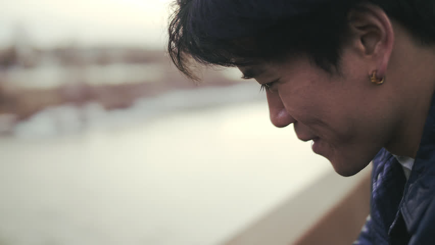 Close up smiling man looking down at waterfront