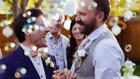 Happy gay male couple dancing getting married in summer backyard - Powered by Shutterstock - Get 15% off with code: PIKWIZARD15