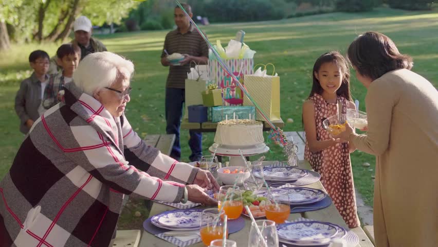 Multigenerational family celebrating birthday in park
