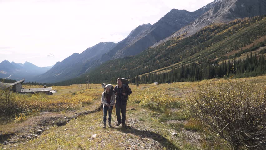Couple trekking in sunny Rocky Mountains Canada