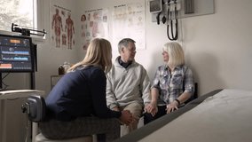 Senior couple talking with primary care doctor in examination room - Powered by Shutterstock - Get 15% off with code: PIKWIZARD15