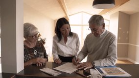 Realtor helping senior couple sign contract offer in house - Powered by Shutterstock - Get 15% off with code: PIKWIZARD15