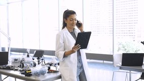 Female robotics engineer with digital tablet talking on smart phone - Powered by Shutterstock - Get 15% off with code: PIKWIZARD15