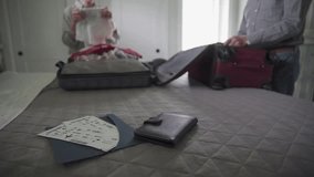 Senior couple packing suitcases for vacation in bedroom - Powered by Shutterstock - Get 15% off with code: PIKWIZARD15