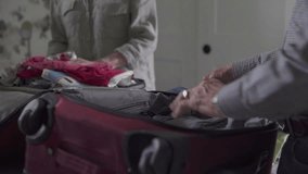 Senior couple packing suitcases for vacation - Powered by Shutterstock - Get 15% off with code: PIKWIZARD15