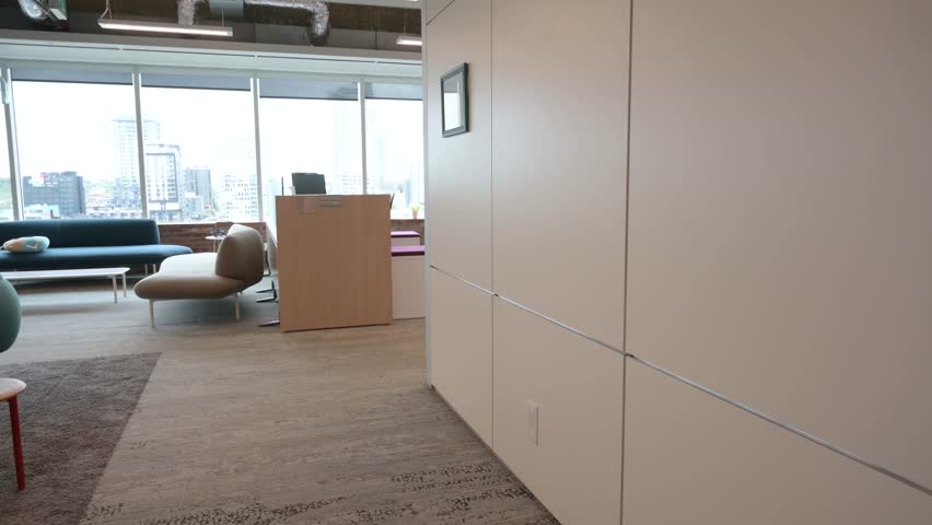 Young businesswoman walking bicycle in urban open plan office