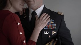 Affectionate wife hugging officer husband in formal military uniform - Powered by Shutterstock - Get 15% off with code: PIKWIZARD15