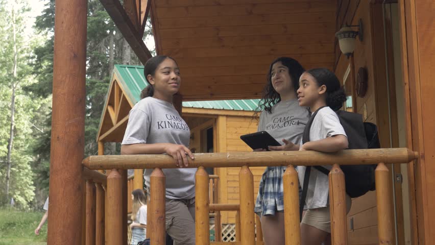 Slow motion of camp counselors talking to young girl