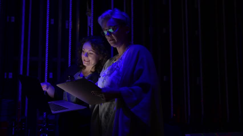 Female event coordinators with laptop backstage