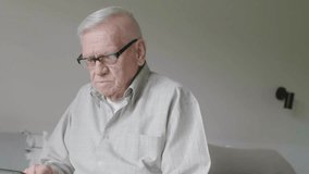 Senior man using digital tablet in bedroom at home - Powered by Shutterstock - Get 15% off with code: PIKWIZARD15