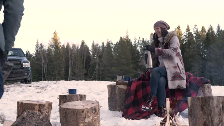 Slow motion of man chopping firewood in snow