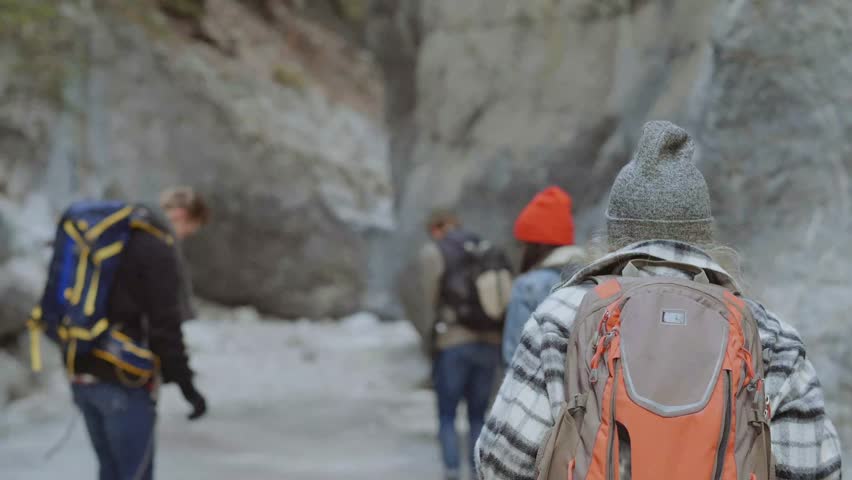 Group of people hing in icy gorge