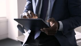 Close up businessman using digital tablet in office - Powered by Shutterstock - Get 15% off with code: PIKWIZARD15