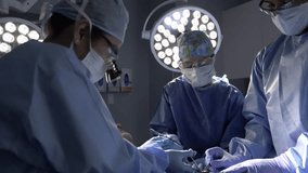Surgeons performing surgery in operating room - Powered by Shutterstock - Get 15% off with code: PIKWIZARD15
