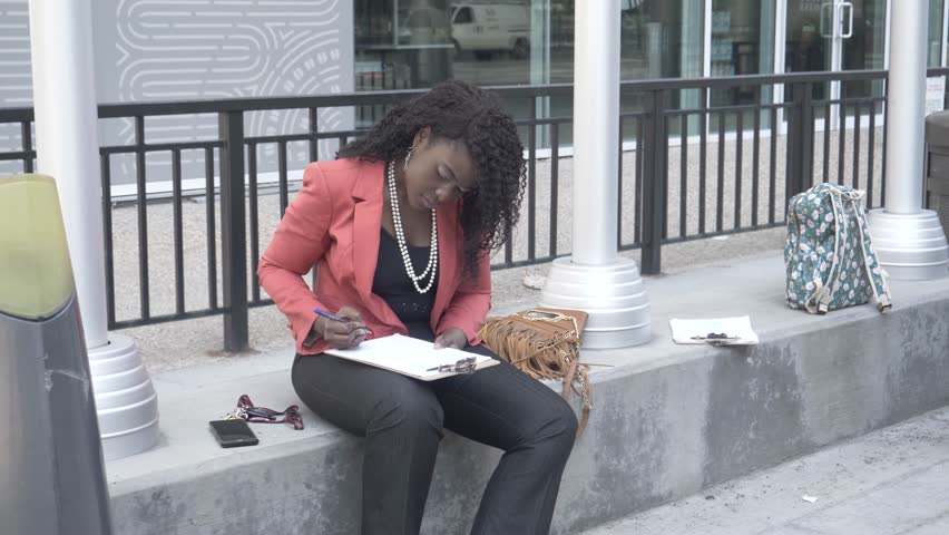 Businesswoman working on city bench