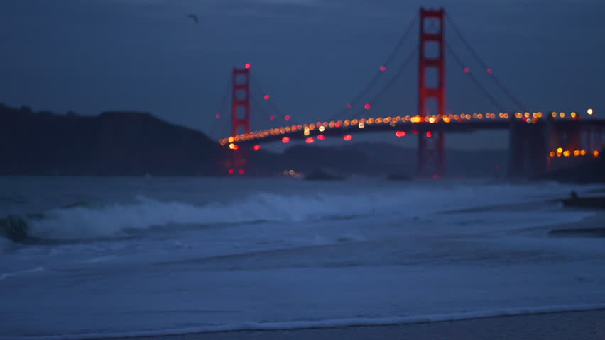 Stunning sunrise over Golden Gate Bridge with ocean waves, clouds, and a dog running along Baker Beach, San Francisco. Perfect for relaxation and meditation.