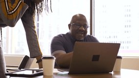 Business people with coffee meeting at laptop in office - Powered by Shutterstock - Get 15% off with code: PIKWIZARD15