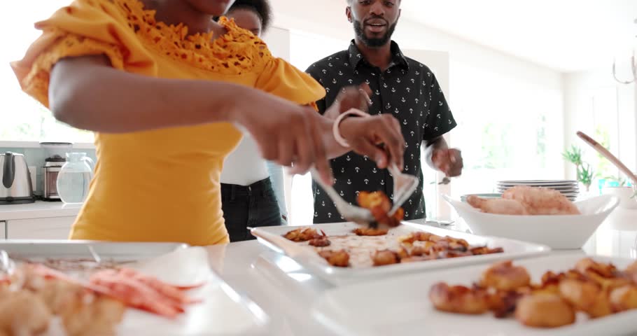 Family preparing and serving potatoes for dinner in kitchen