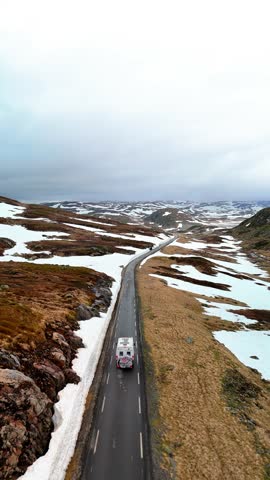Campervan or motorhome travel camper van, Caravan trailer, or camper RV at the Lyse road covered with snow to Krejag Norway Lysebotn, road covered with snow in May