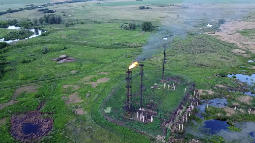 Oil and gas industry. Refining and pumping of oil and gas. Combustion of associated gas. Torch at the oil station. The video was made from a drone.