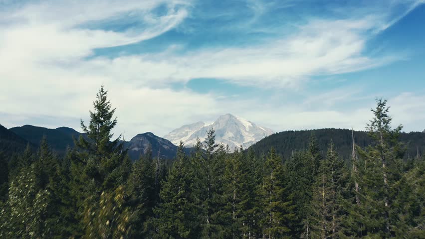 Incredibly gorgeous drone aerial shot that tracks forward of Mt Rainier in Washington State.