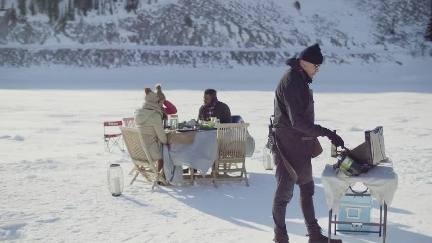 Slow motion of man cooking at luxury outdoor dining