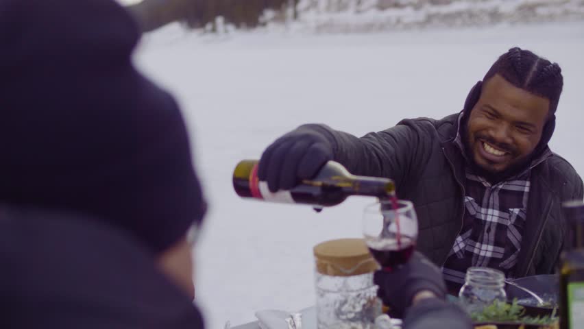 Slow motion of friends enjoying wine at luxury outdoor dining