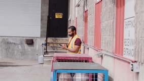 Slow motion shot of warehouse worker texting near loading docks - Powered by Shutterstock - Get 15% off with code: PIKWIZARD15