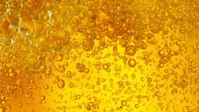 Super Slow Motion Shot of Golden Oil Bubbles Flowing in Water at 1000fps. - Powered by Shutterstock - Get 15% off with code: PIKWIZARD15