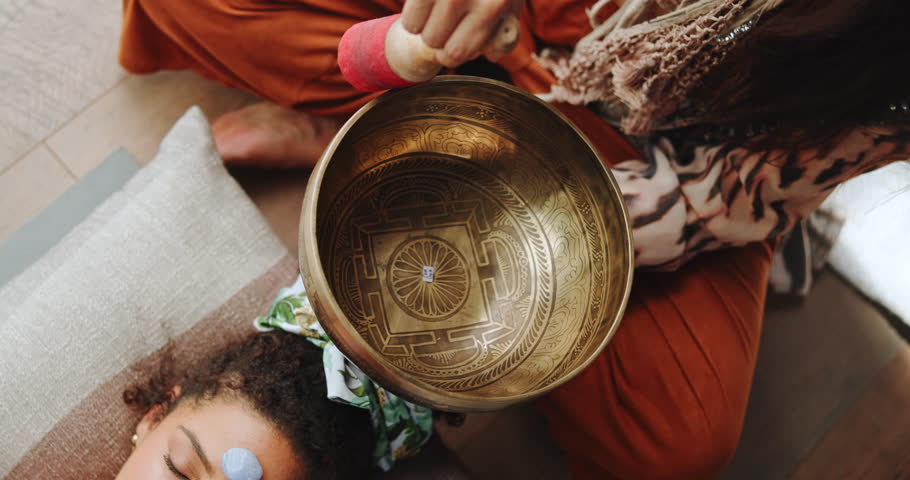 Singing bowl, meditation and woman on floor with healer for sound therapy, vibration or chakra balance from above. Healing, crystal or female person with shaman for energy, cleaning or holistic care