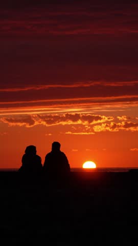 Sunset, beach and back couple hugging in evening on vacation, summer vacation and weekend by ocean. Nature, love, man and woman embrace, and relax for unity, by sea.