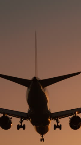 Vertical Screen: A vertical video of an airplane landing at sunset, displaying the silhouette of the aircraft against the twilight sky. The scene captures the beauty and serenity of a planes arrival