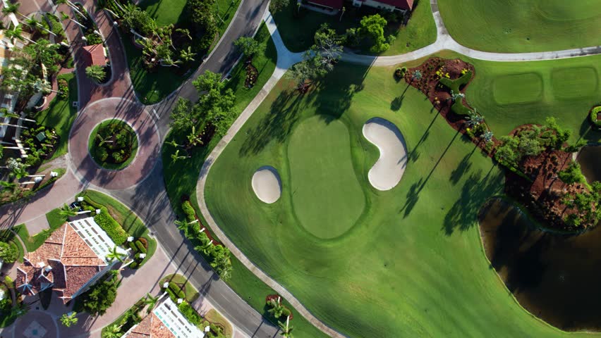 Drone aerial view looking down at a perfectly curated golf course putting green