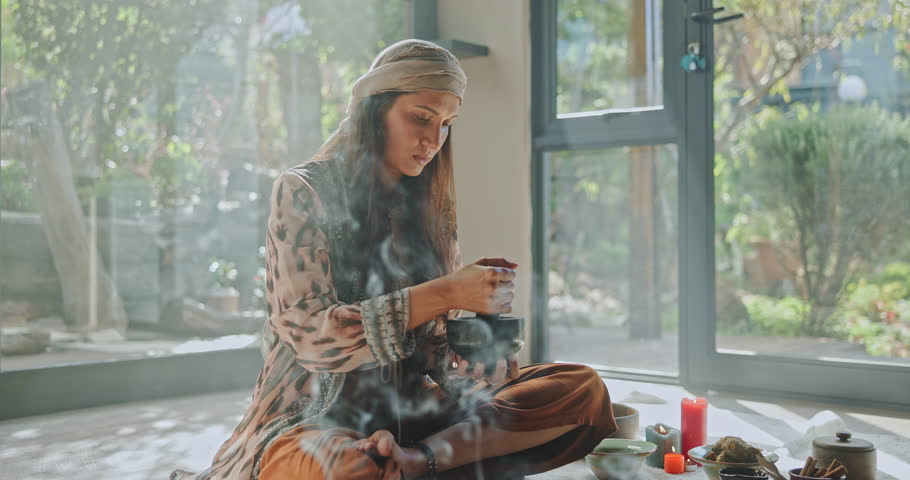 Aromatherapy, herbs and woman with healing ritual for mindfulness, peace and boho energy. Zen, meditation and girl at retreat with alternative medicine for spiritual balance for mind, body and soul.