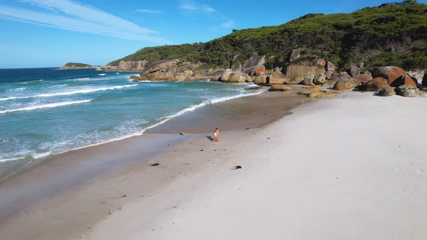 4K Drone video panning back and out of the beautiful beach at Wilsons Promontory in Victoria, Australia. The natural landscapes show lush greenery, cliff rock formations and the vast blue ocean.