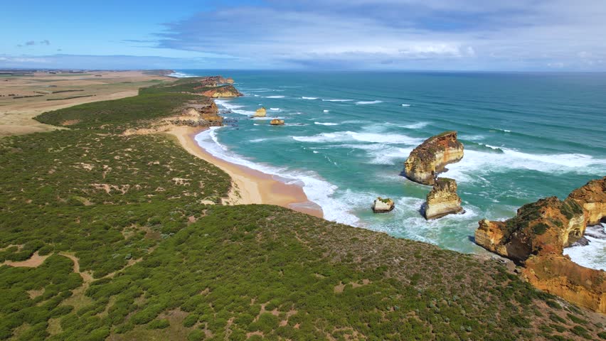 4k Drone video flying forward over the 12 Apostles on the Great Ocean Road, Australia. The white sand beaches combined with the blue ocean and vast green nature make the landscapes mesmerising.