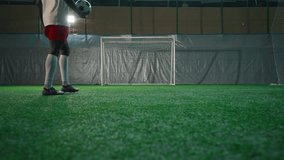 Black soccer player exercising penalty in training hall, scoring goal, back view. Sport training of national team before match and competition, African American man is forward or halfback, empty gate - Powered by Shutterstock - Get 15% off with code: PIKWIZARD15