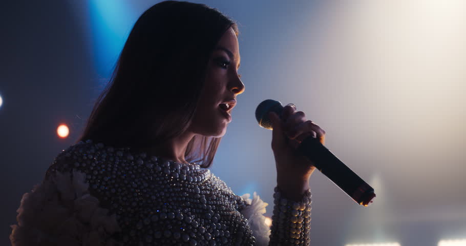 Portrait of a Female Singer Singing an Emotional Song. Spectacular Concert with a Talented Pop Star. Her Soulful Voice and Catchy Tunes Keep the Audience Vibing to the Sounds of Modern Dance Music