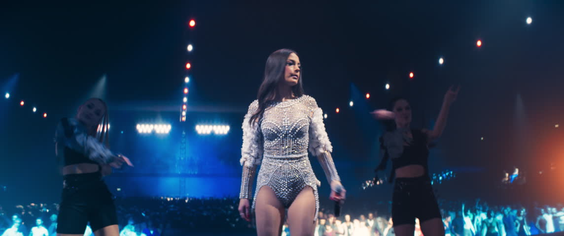 Female Pop Singer Lights Up the Night With a Creative Performance. Music Fans Dance in the Fan Zone as Dazzling Choreography and Stunning Visuals Create a Magical Atmosphere on Stage. Anamorphic Shot