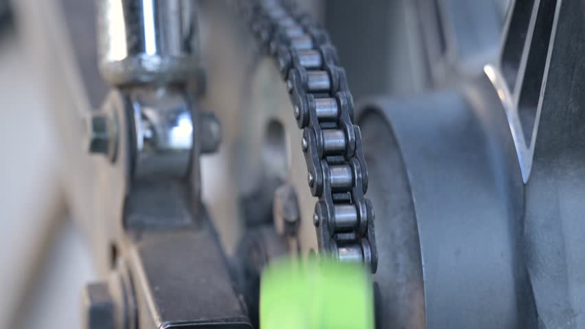 Cleaning motorbike chain with a brush. Maintenance of motorcycle, cleaning and lubrication of chain