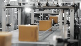 Cardboard boxes moving along an automated packaging conveyor line in a modern factory, showing industrial logistics, automation and high speed production workflow. - Powered by Shutterstock - Get 15% off with code: PIKWIZARD15