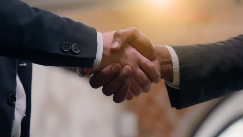 Close up two success businessmen multiracial diversity multiethnic business people partners partnership teamwork cooperation deal greeting welcome office hire African Asian men handshaking shake hands