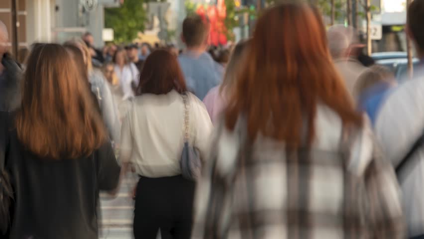 Time lapse of a crowd of people walking along the street during the day. The concept of daily bustle and routine