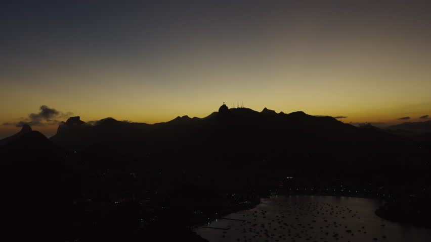 Rio de Janeiro at sunset. Shading mountain with Corcovado statue Brazil