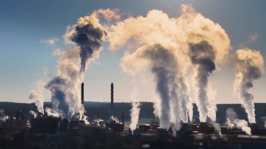Ugly sight of factory chimneys causing air pollution by emitting gases, aerial