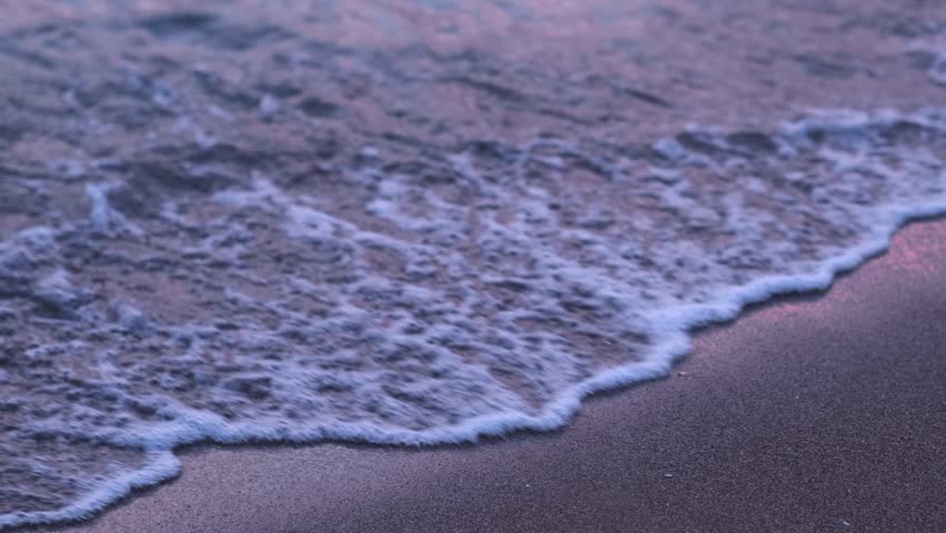 Evening seashore with wave close up. Calm night ocean water waves splashing sandy beach. Closeup sea waves breaking sand beach at summer morning. slow motion. nature background travel relax. no people - Powered by Shutterstock - Get 15% off with code: PIKWIZARD15
