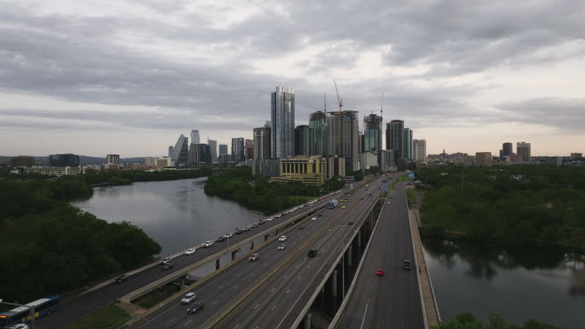 Aerial view over cars on the I-35 bridge on the Colorado river in cloudy Austin