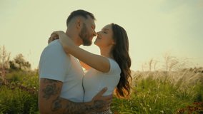 Happy romantic loving Caucasian couple man woman tender family wife husband kiss guy hug girl showing love hugging embracing kissing outdoors deserted wheat field sunrise sunshine dating relationship - Powered by Shutterstock - Get 15% off with code: PIKWIZARD15