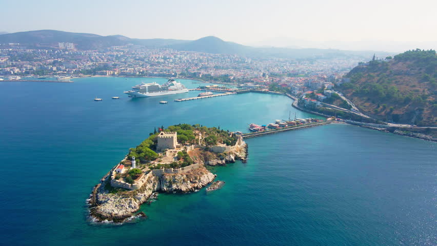 Pigeon Island in town Kusadasi, Turkey with cruise ship moored in pier. Aerial view